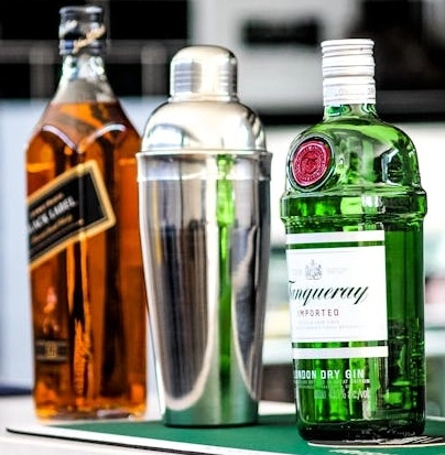Gin, whisky and a cocktail shaker for home cocktails from ABLO Liquor Calgary