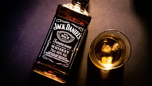 Premium Tennessee whiskey bottle beside a tumbler of whisky on the rocks at ABLO Liquor Calgary
